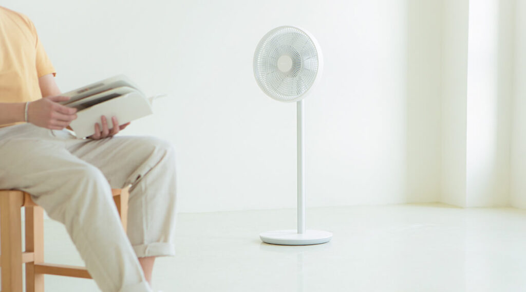 The Smartmi fan in a room with a person.