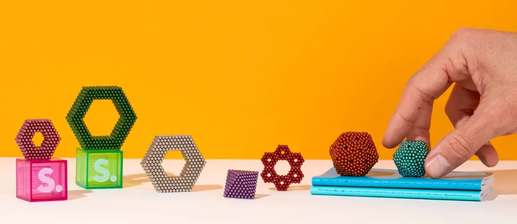 A variety of different colored sets of Speks magnets in various shapes.