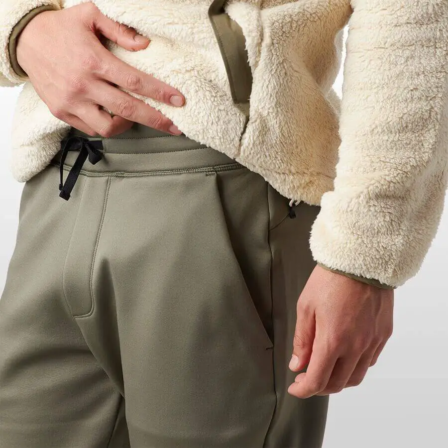 A man wearing his Backcountry Timpanogos Tech Fleece pants.