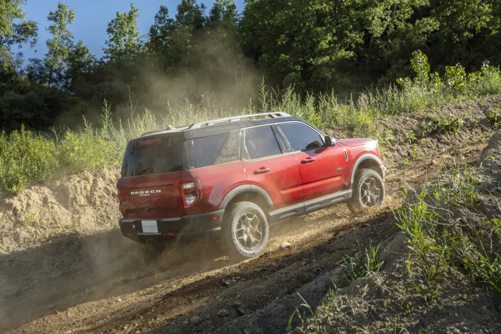 The 2021 Ford Bronco Sport Badlands using G.O.A.T. feature as it climbs up a steep dirt hill.