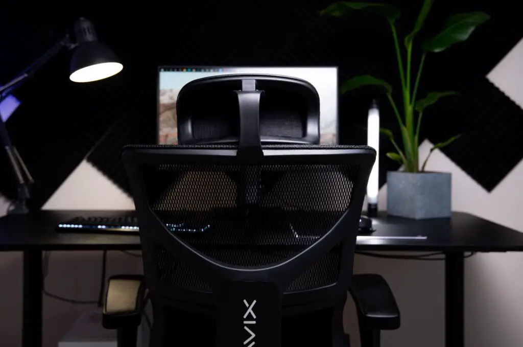 The Mavix M5 Gaming Chair from the back facing a professional desk.