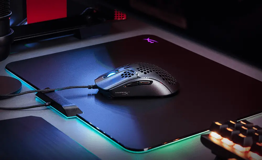 The HyperX Pulsefire Haste mouse displayed on a beautiful RGB mousepad.