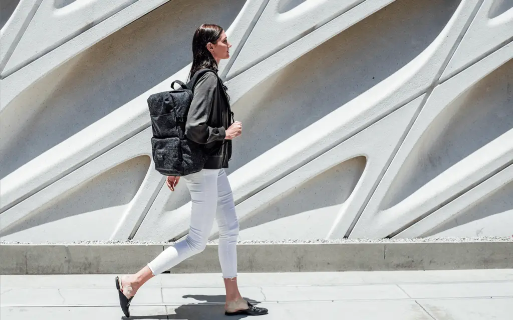 A woman using her Technical Backpack from Hex to walk around the city.