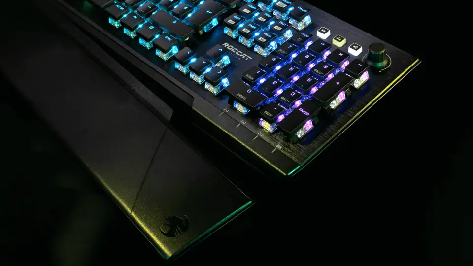 The Vulcan Pro Optical-Tactile gaming keyboard on a black surface with its brilliant RGB lighting displayed.