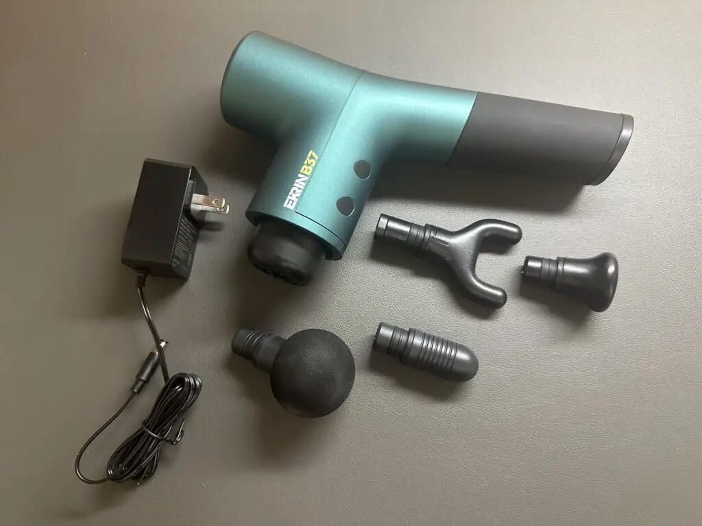 Ekrin B37 Massage Gun with four attachments and charging adapter. 