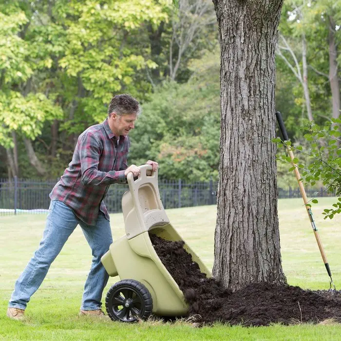 man using wheelbarrow for yard work