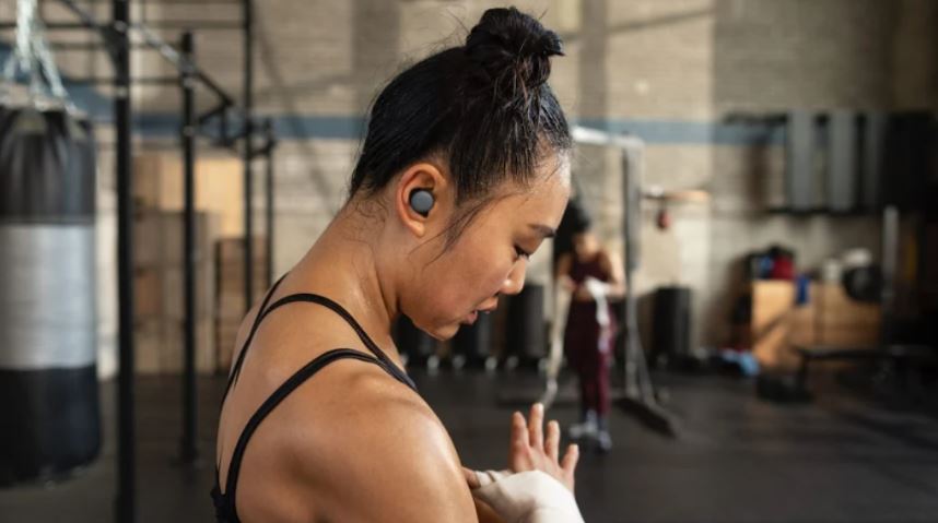 girl using wireless Google Pixel buds while working out