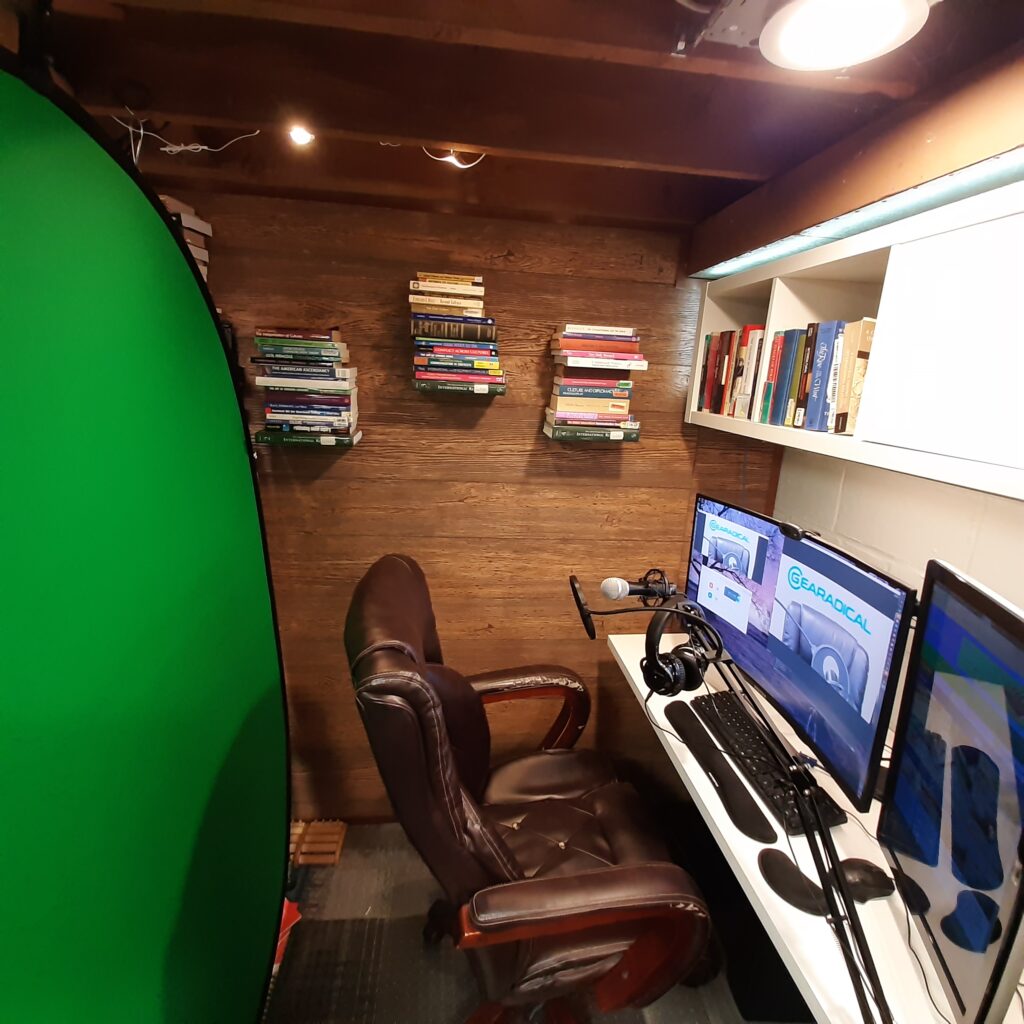 The Kshioe Collapsible Greenscreen in an office behind a computer.