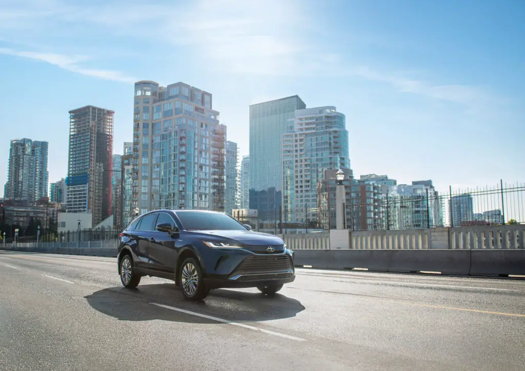 The 2021 Toyota Venza Limited driving down a city street.