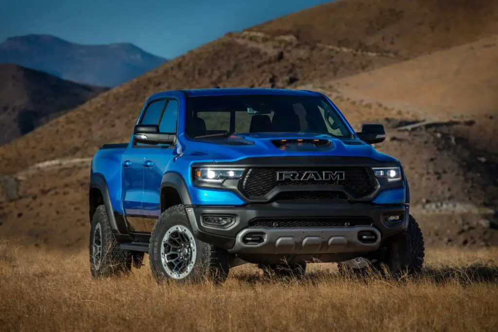 The 2021 Ram 1500 TRX in field by the mountains.