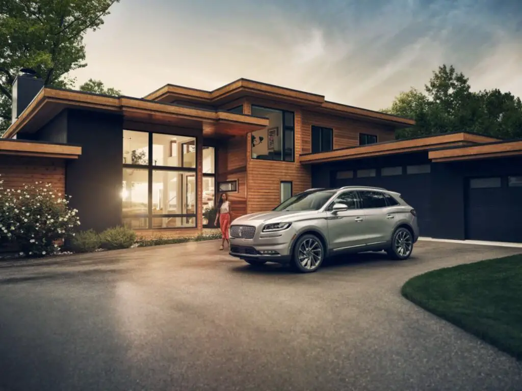 A 2021 Lincoln Black Label Nautilus AWD parked outside a modern-style house.