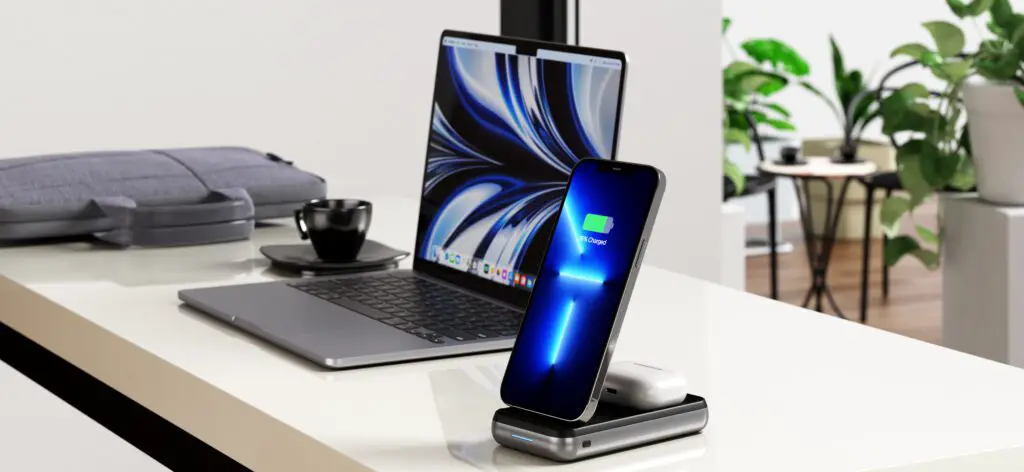 Satechi Duo Wireless charger charging iPhone and Airpods next to Macbook Pro